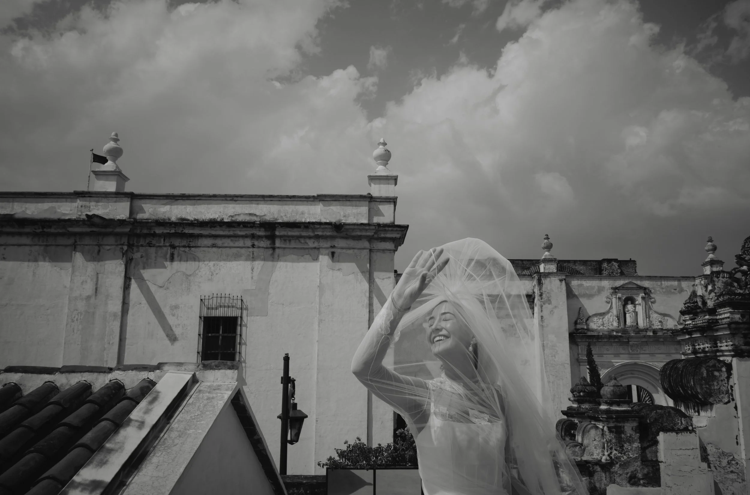 Bride beneath historic architecture in Antigua Guatemala