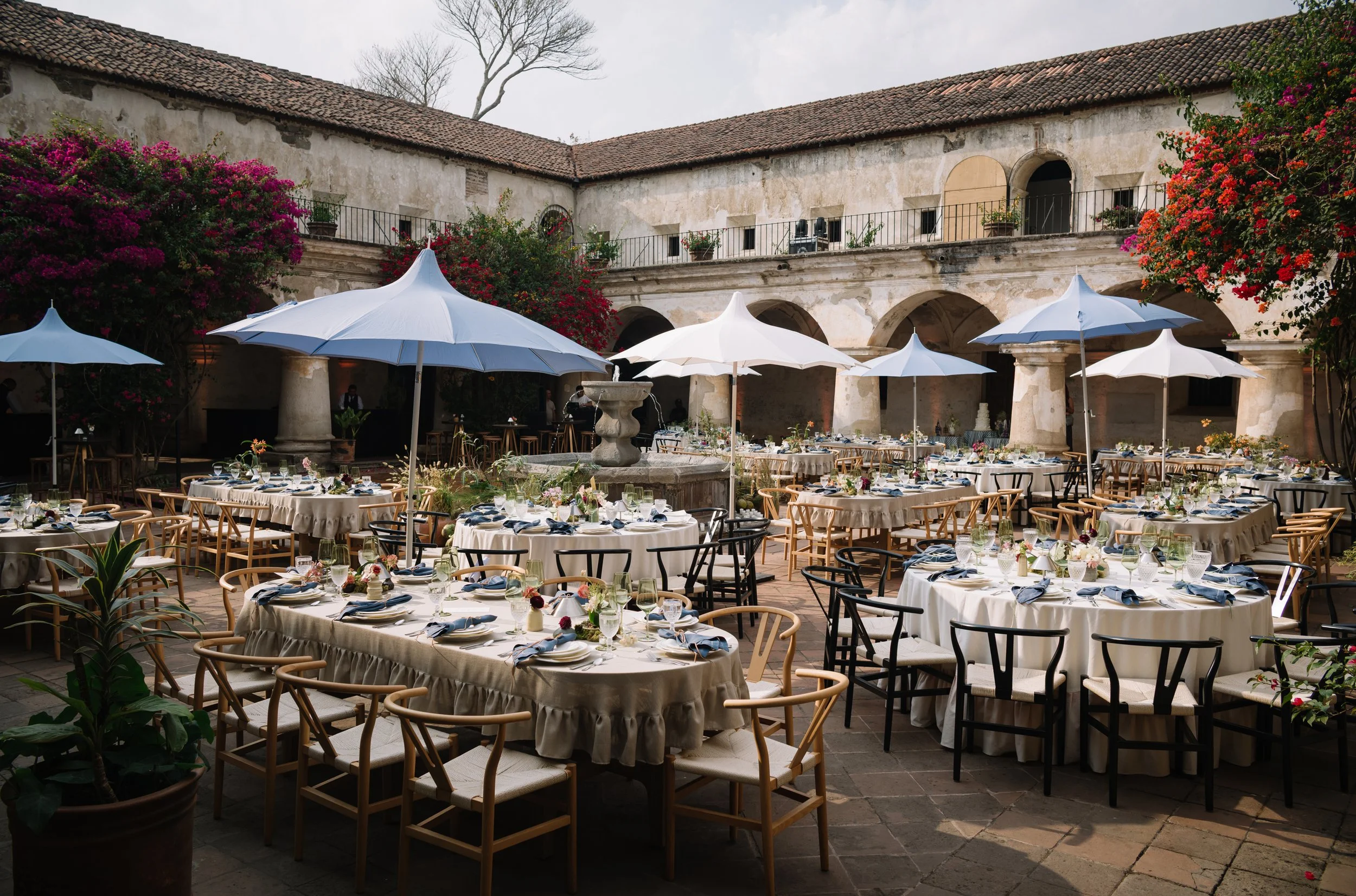 Reception tables beneath bougainvillea at Casa Tridentino