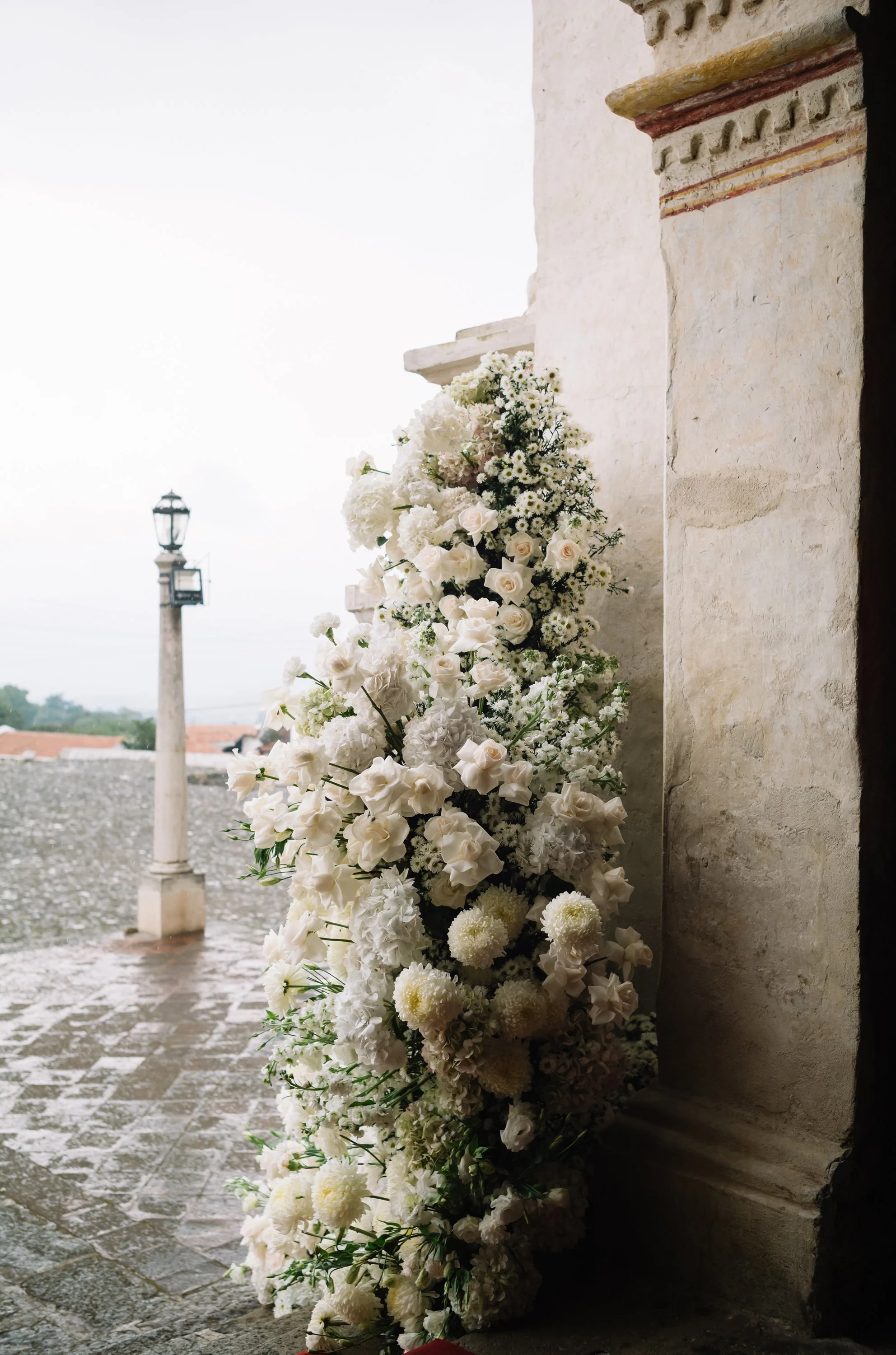 Wedding ceremony florals at San Juan del Obispo Church during a luxury destination wedding in Antigua Guatemala.