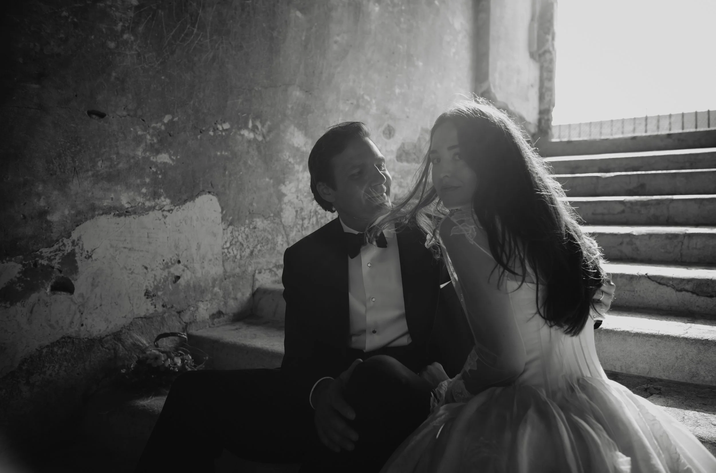 Black and white Couples portraits beneath historic architecture in Antigua Guatemala