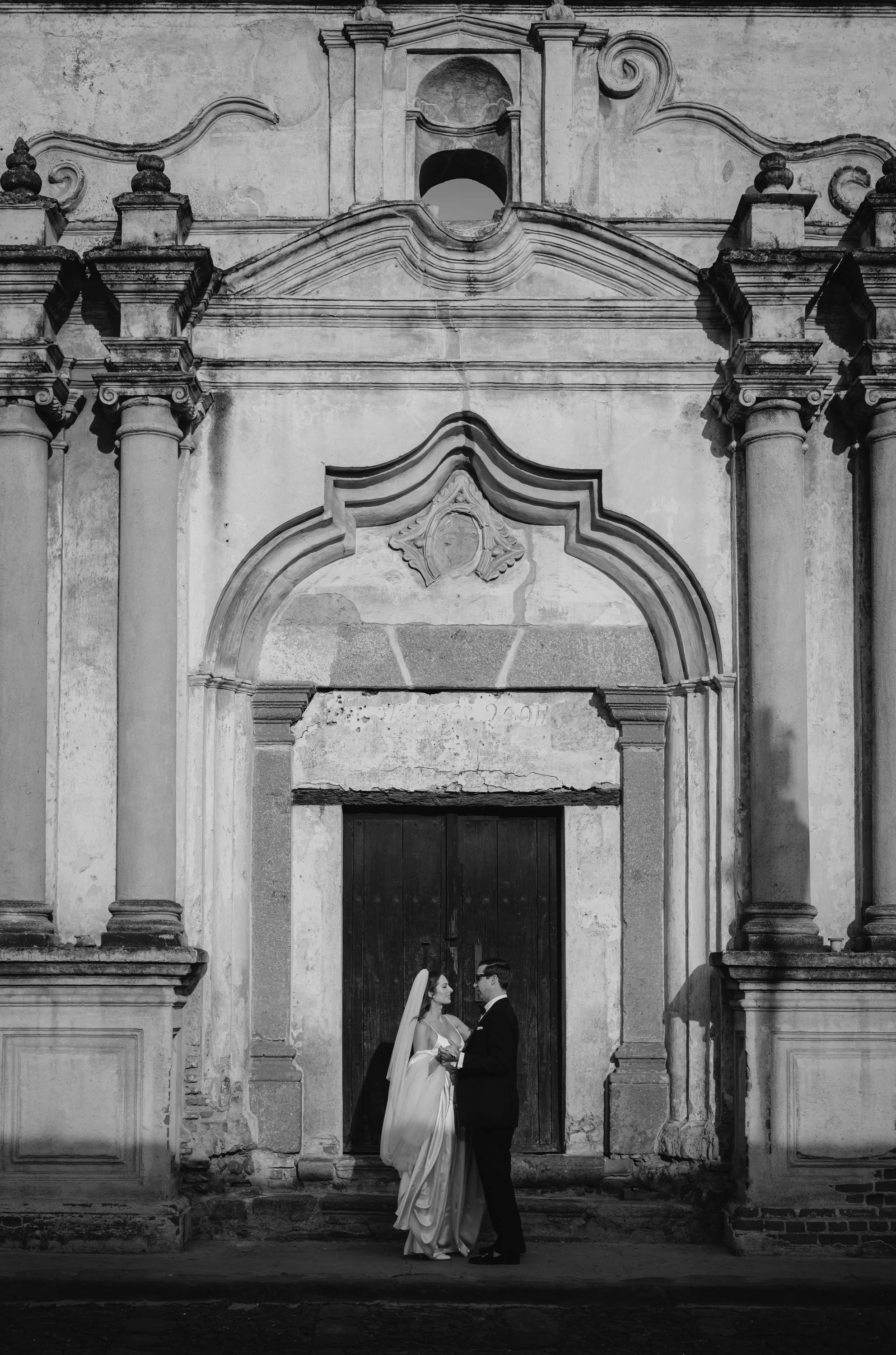 Editorial destination wedding portrait of a bride and groom on the cobblestone streets of Antigua Guatemala