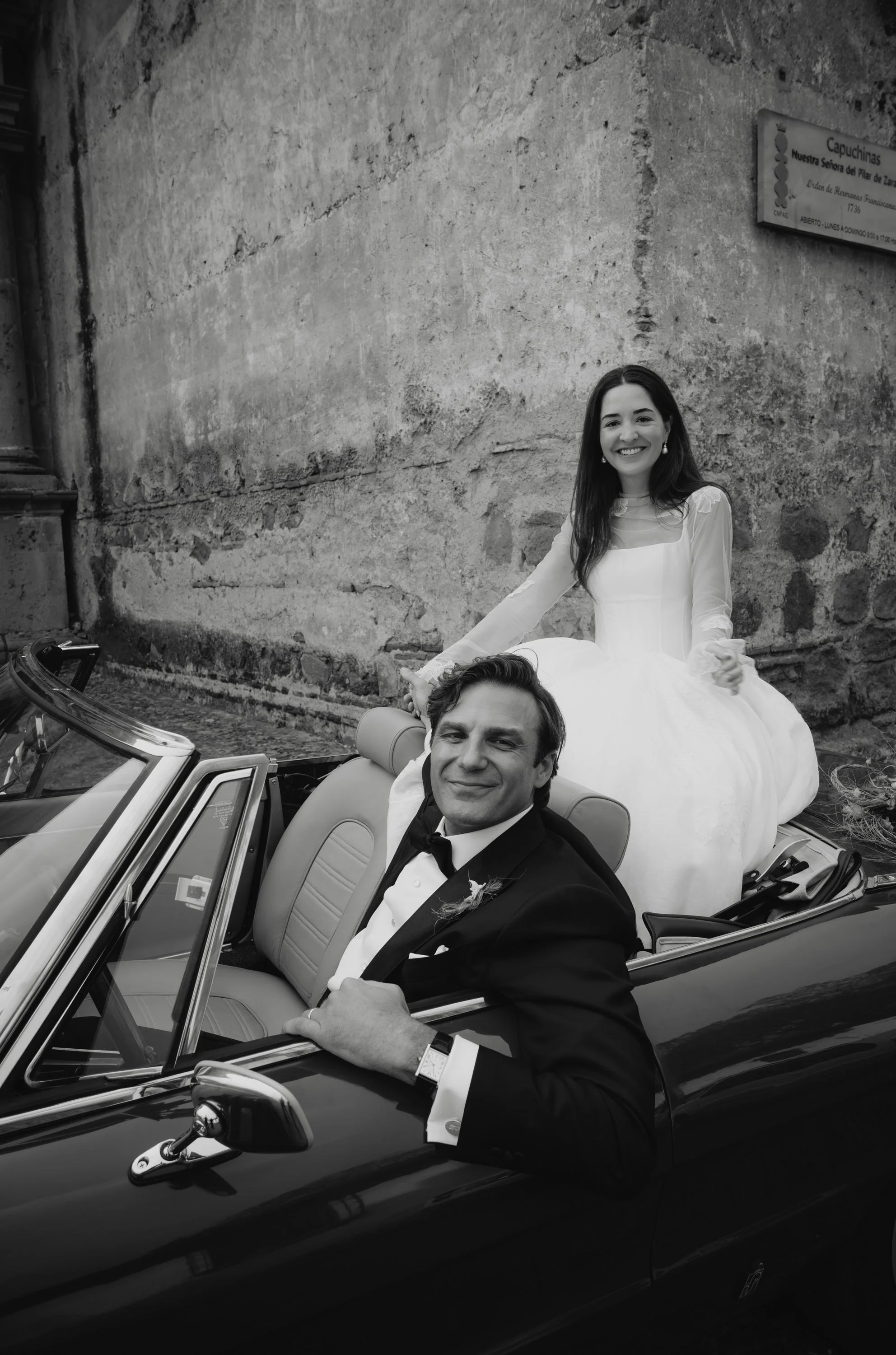 Bride and groom driving a vintage Alfa Romeo in Antigua