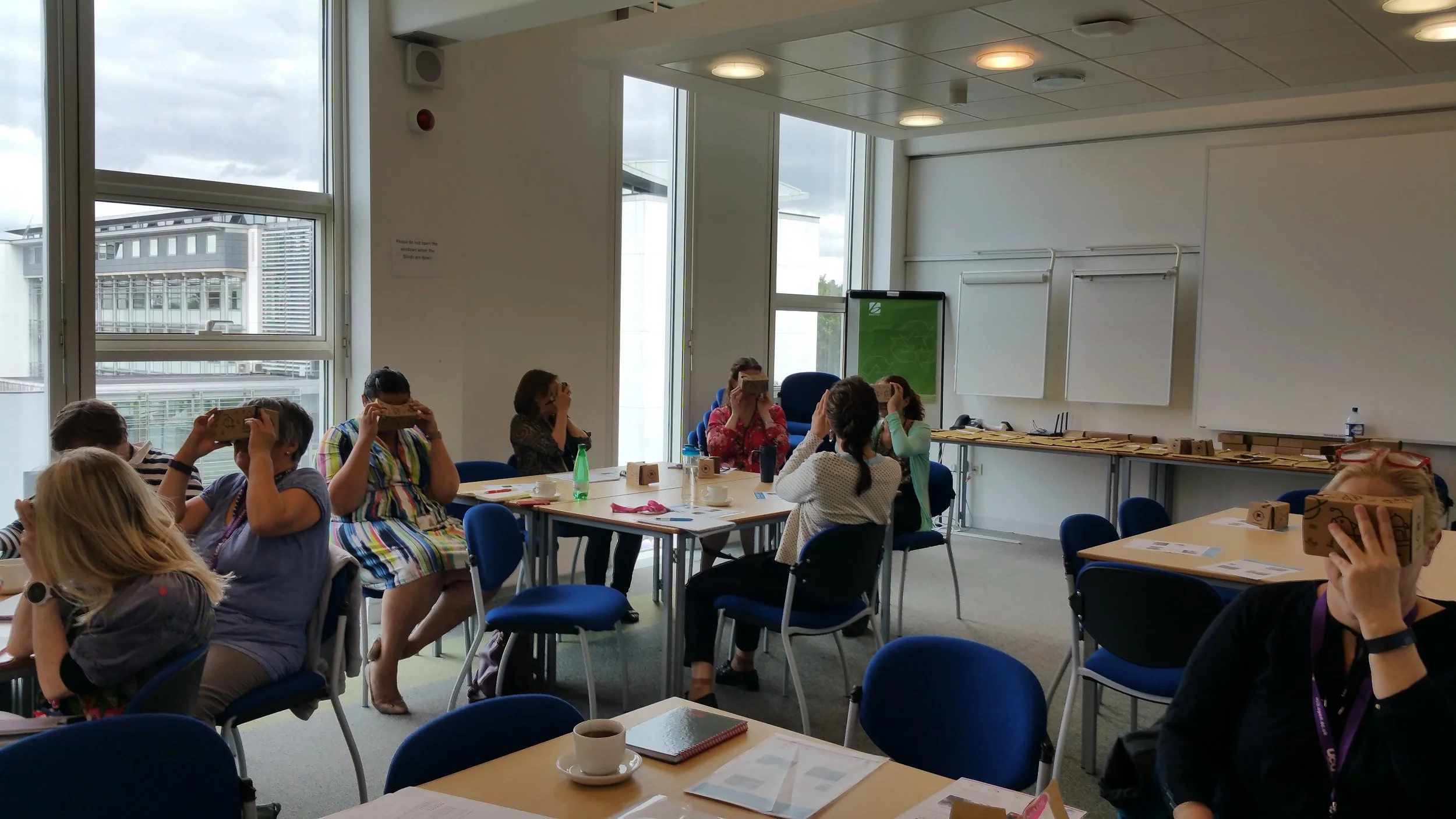 Photo from the workshop of the Employability and Scholarship Network of The Open University, UK. Participants are looking at Google Expeditions via the virtual reality viewers.