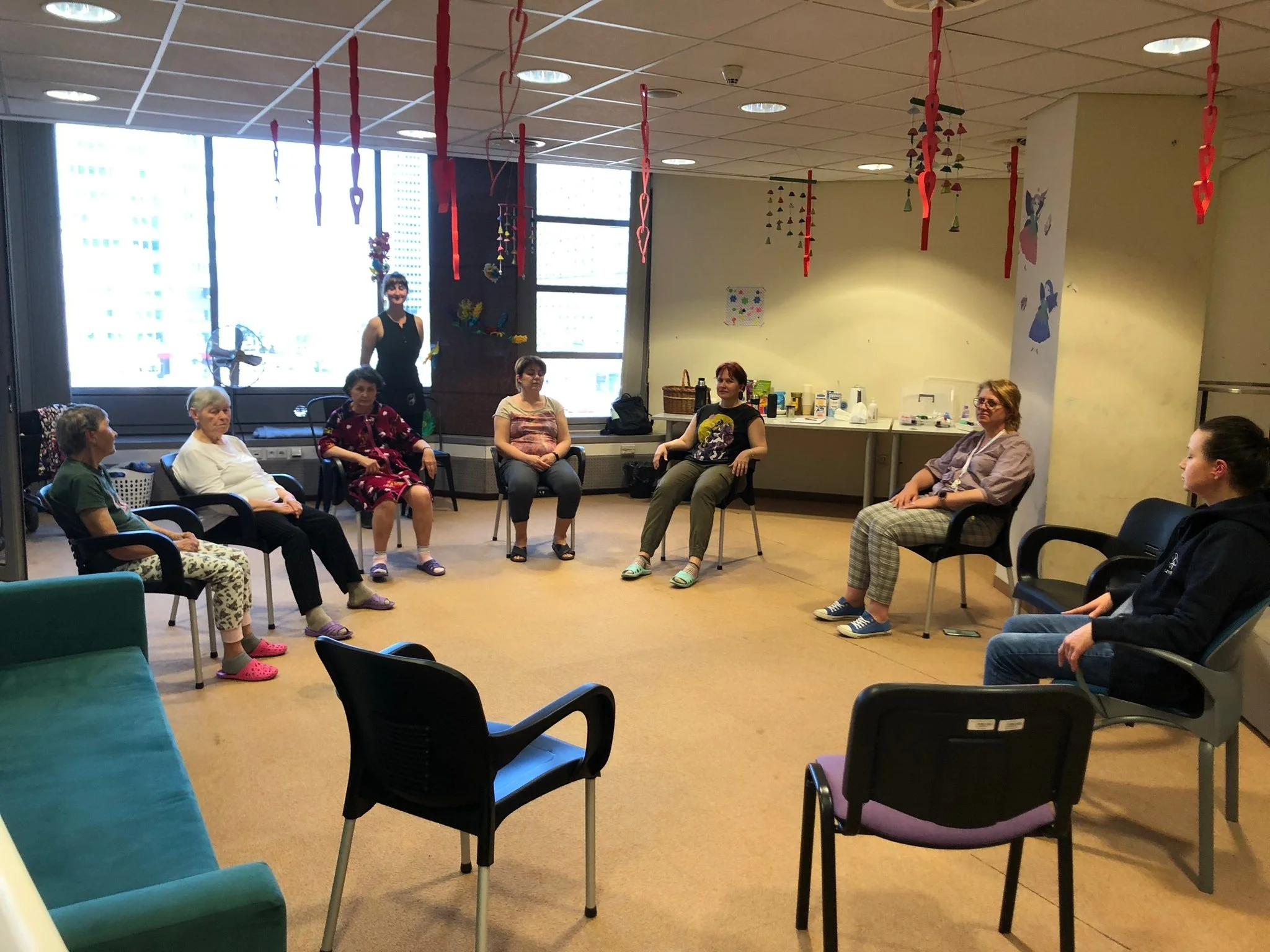 women sitting around in a circle getting ear acupuncture