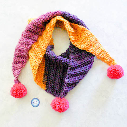My "mod scarf" patterns are some of my favorites, so I decided to make a mini version for my daughter! This simple and modern scarf is adorned with pom poms and is perfect for children. Keep reading for the free crochet pattern.