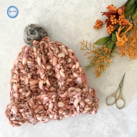 When I started working on this project I wasn't sure if this yarn was going to become a hat or a cowl - I just knew I had to make something out of this yummy luxury yarn that I bought on a whim at Joann's! I opted for a hat because I've made a lot of scarves lately, but truly you could make an beautiful cowl with one skein of this Buttercream Thick & Thin yarn as well. Keep reading for the free crochet pattern!