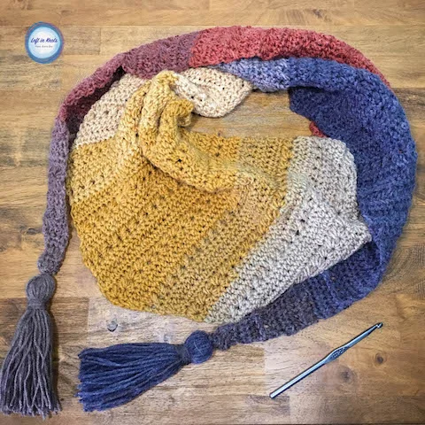 The Crunching Leaves Mod Scarf features all the best warm fall tones with just one cake of Lion Brand Mandala yarn! This trendy triangle scarf will keep you warm all fall and winter long. Read more for the free crochet pattern.