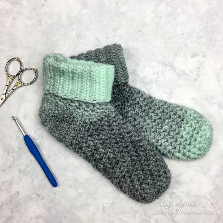 Use the rest of your Seven Days of Scarfie “Day 4” skein to crochet these coziest slipper socks! Or you may as well grab a couple of skeins, because you will want a few pairs of these for yourself too :) This free crochet pattern makes the Wintermint Slipper Socks in three sizes that will fit most adult women. The cuffed ankle keeps them in place, and the ever fuzzy Scarfie yarn will keep your feet warm for days!