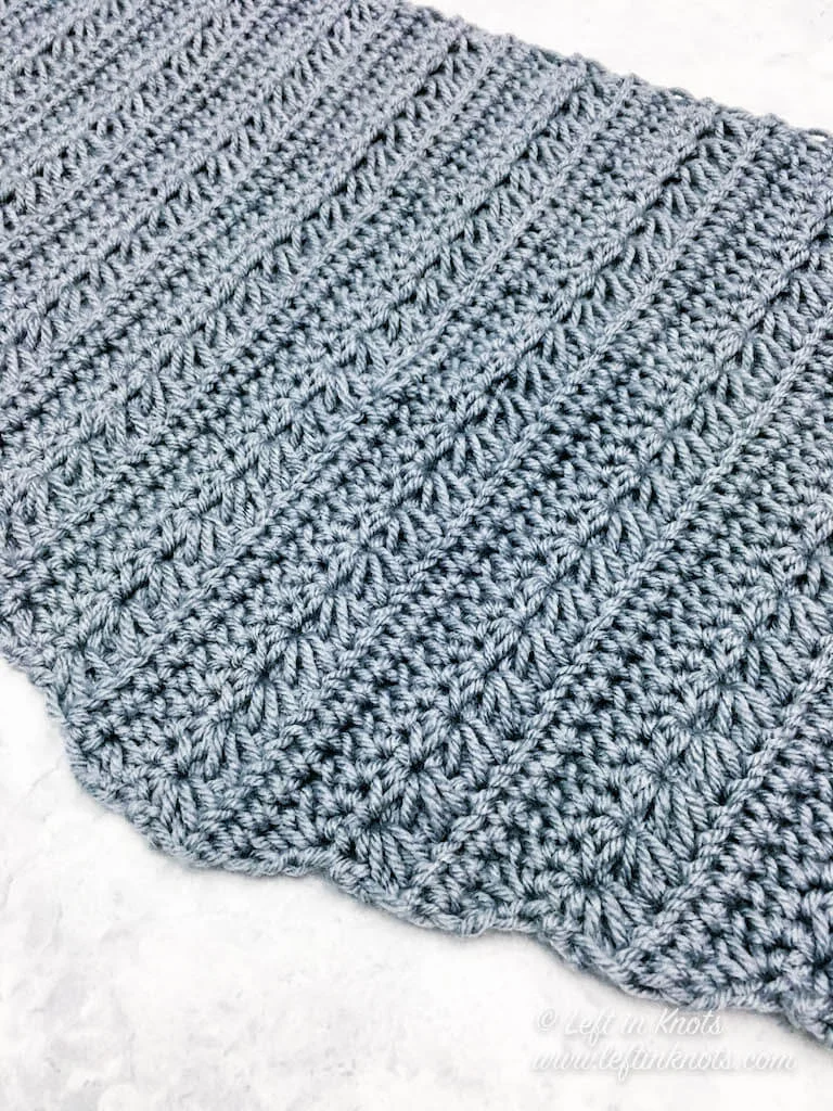 The Snow Drops Mod Scarf is a modern one skein triangle scarf that highlights the stunning texture of the star stitch. You can make this free crochet pattern with just one skein of Caron Cakes yarn or with any worsted weight yarn you have in your stash