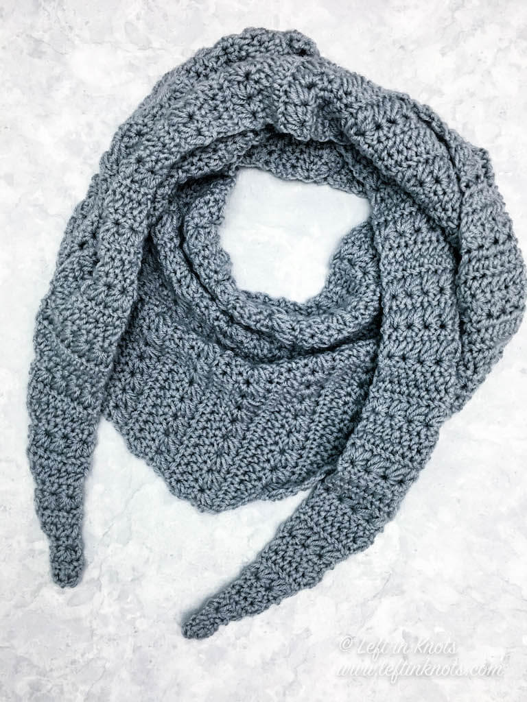 The Snow Drops Mod Scarf is a modern one skein triangle scarf that highlights the stunning texture of the star stitch. You can make this free crochet pattern with just one skein of Caron Cakes yarn or with any worsted weight yarn you have in your stash