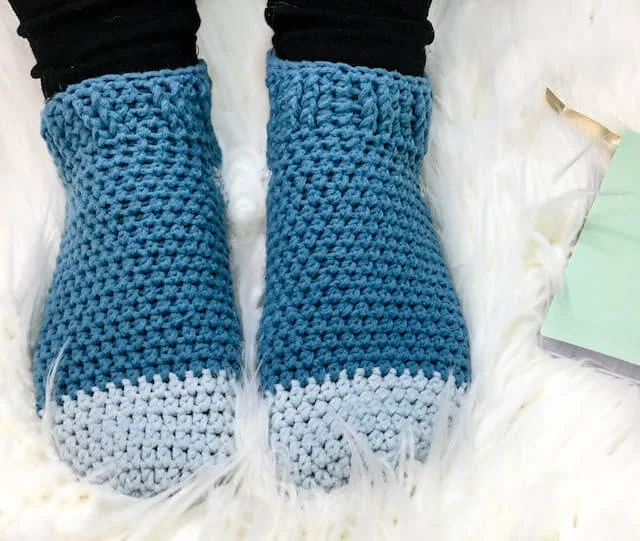 This free crochet pattern uses less that one skein of yarn to make easy crochet slipper socks. Use Lion Brand Ferris Wheel yarn to create a beautiful colorful gradient in brights or neutrals. Or if you prefer, substitute your favorite Category 3 yarn and make these simple slippers in easily adjustable sizes.