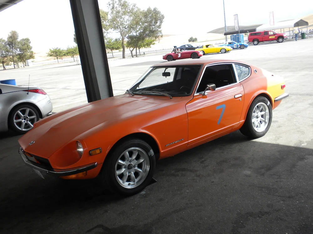 1972 Datsun 240z Thunderhill Raceway Orange black and white.jpg