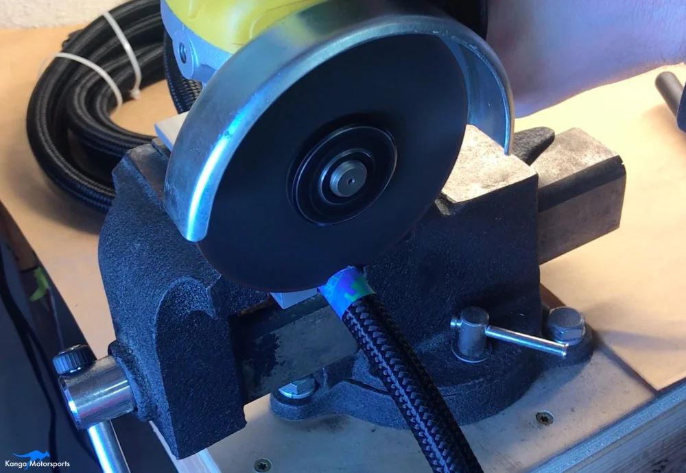 Kanga Motorsports AN fittings cut hose in vise masking tape.jpg