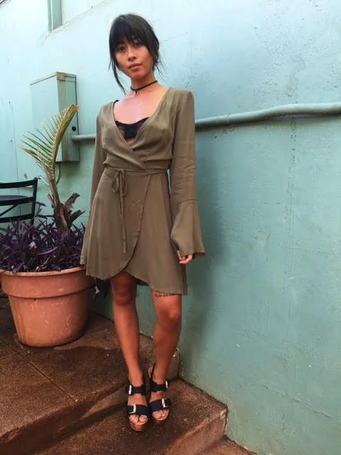 A wrap dress is great for most sizes, but this particular style is great for our petite customers. You can self-adjust it to your liking. The over-sized bell sleeves add to the bohemian flair of this olive-tone dress. The length is above the knee too, which we know how important that is for our petite customers. 