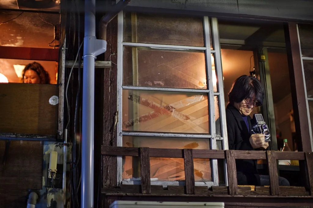 Daido Moriyama busy not personing in a Shinjuku bar. Photo by the TC Lin.