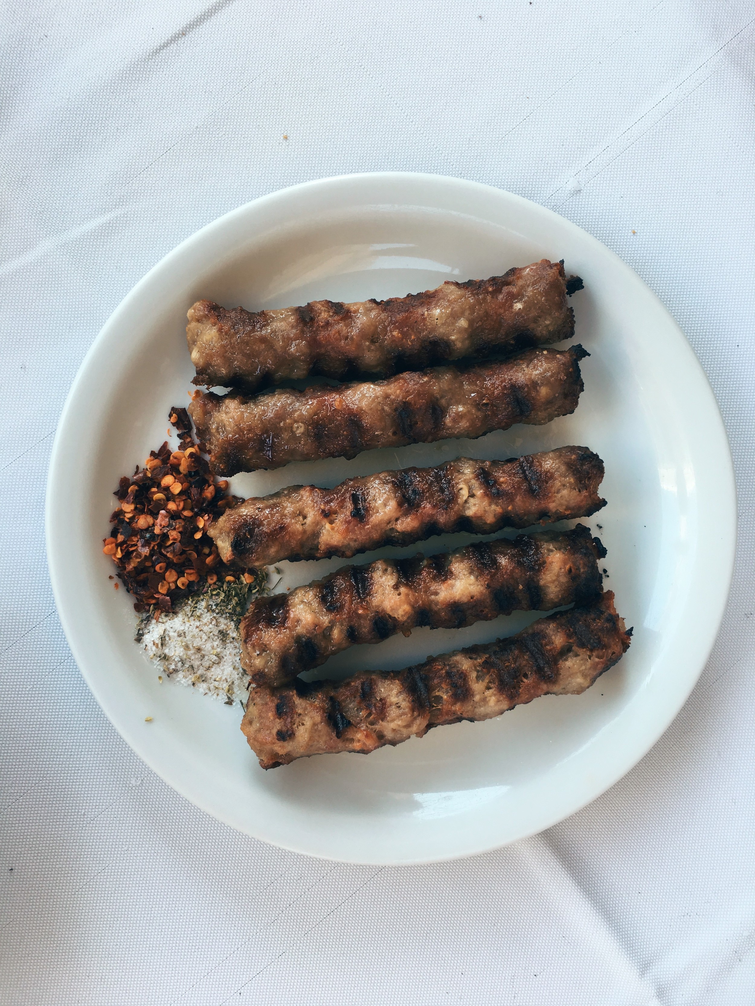 Beef meatballs served with boukovo (chilli-powder), salt and oregano. Served at Ariston
