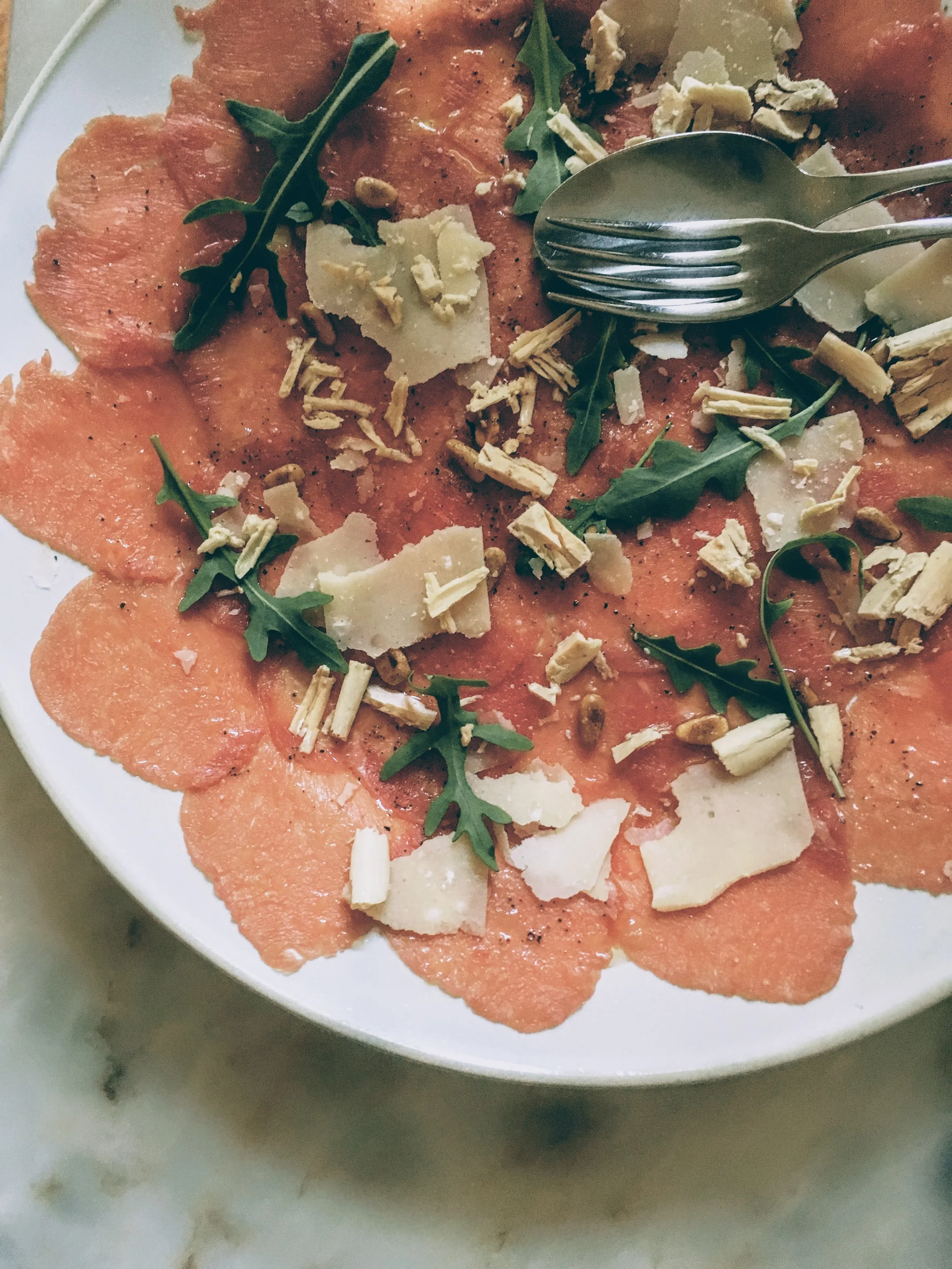 Beef carpaccio sprinkled with foie gras shavings, parmesan cheese and rocket, at Pizzaria Lisboa