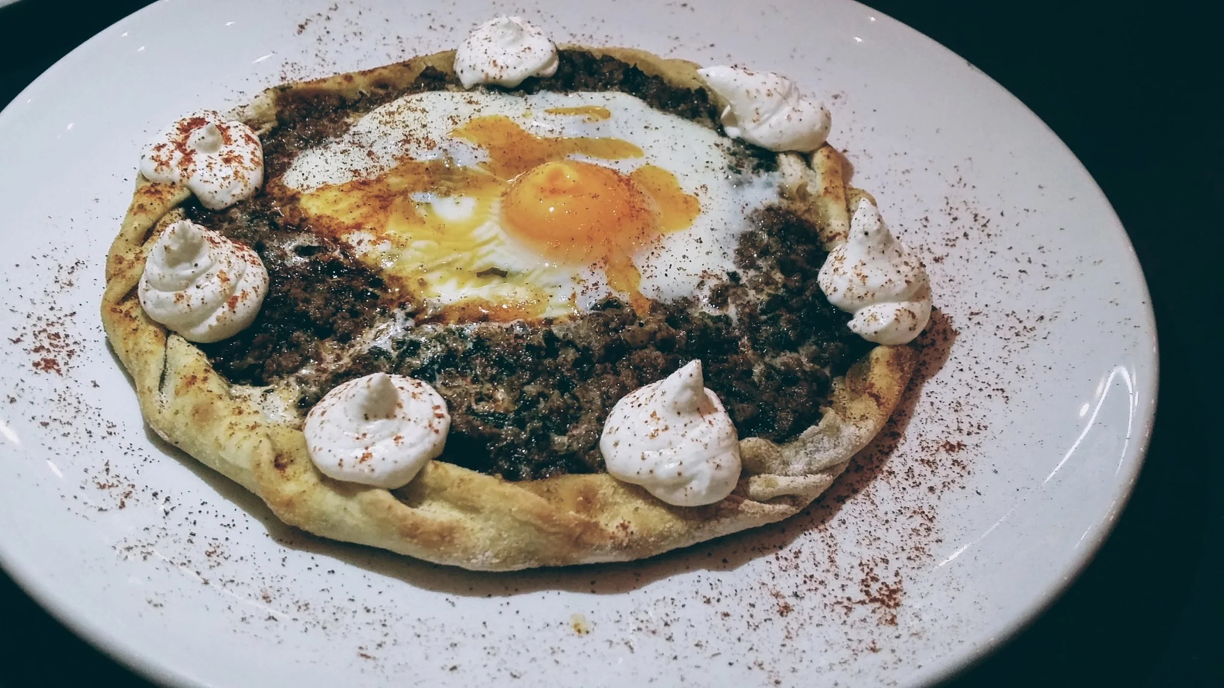 Baked minced meat pie, garnished with a medium cooked egg