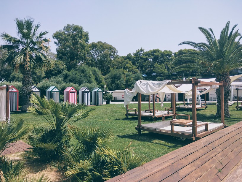 Lounge beds and colored-striped changing rooms at Astir beach