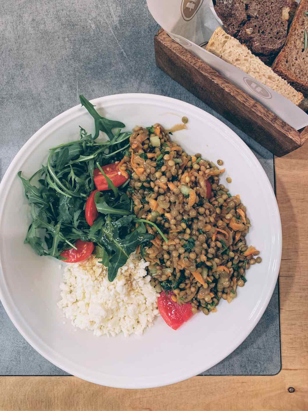 Lentil salad with crumbled cheese and wild rocket salad
