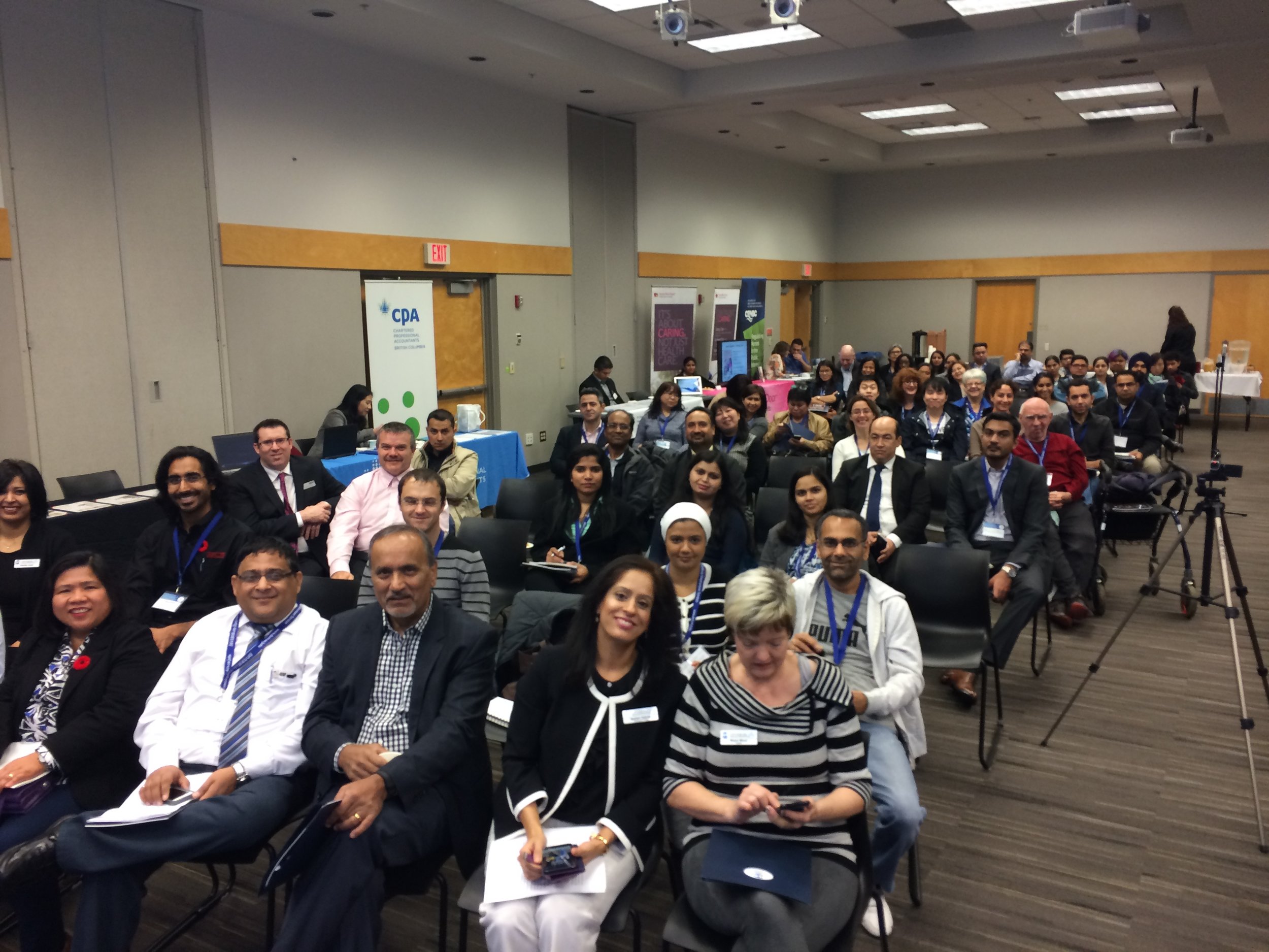 Front row (left to right): Maria Elgin Abais, Rajiv Vasdev, <?>, Neelam Sahota, (CEO, DIVERSEcity Community Resources Society), <BOARD MEMBER>. 