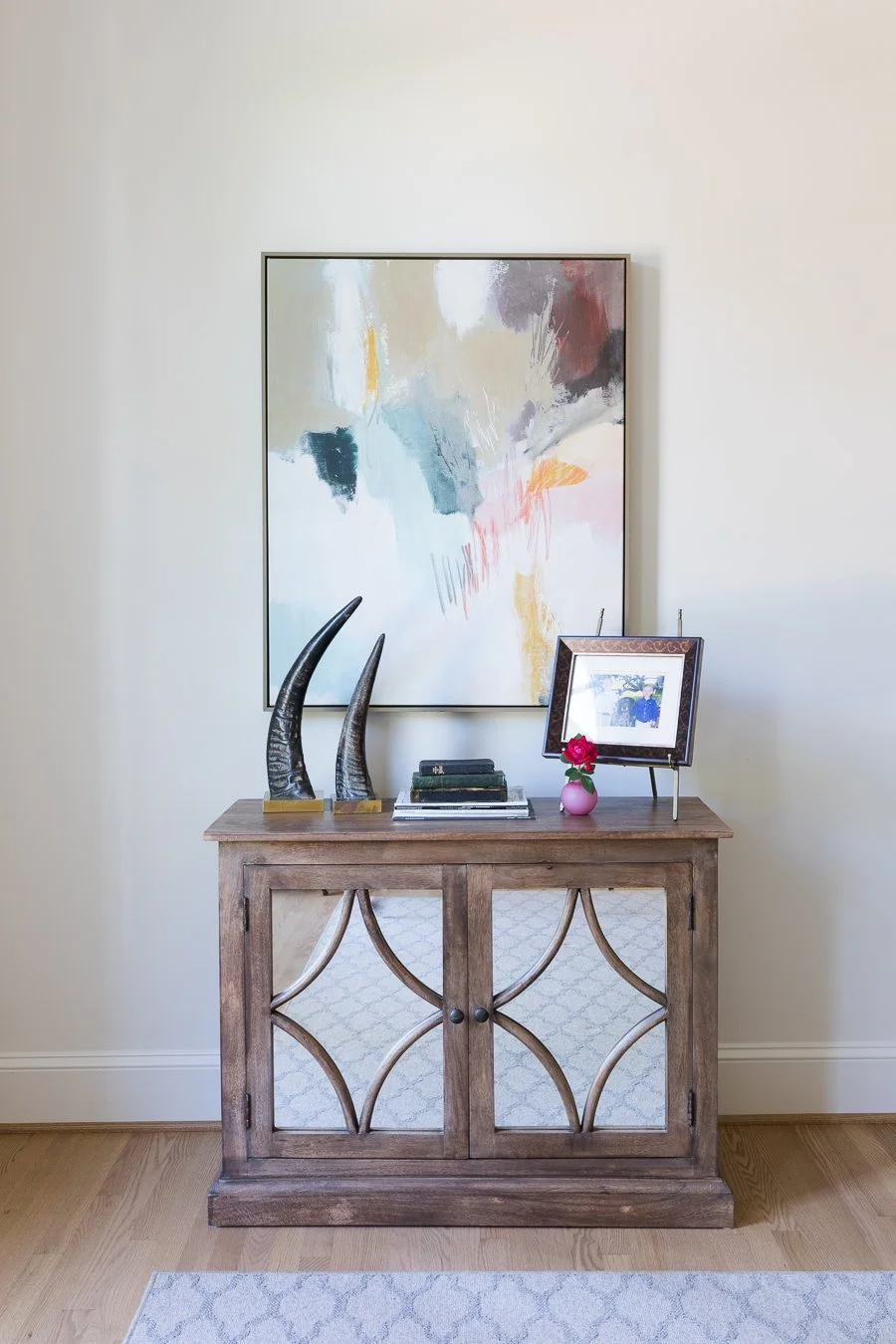 Cabinets with mirrored doors always provided additional light and another texture .. inexpensive artwork brings in color without breaking the bank