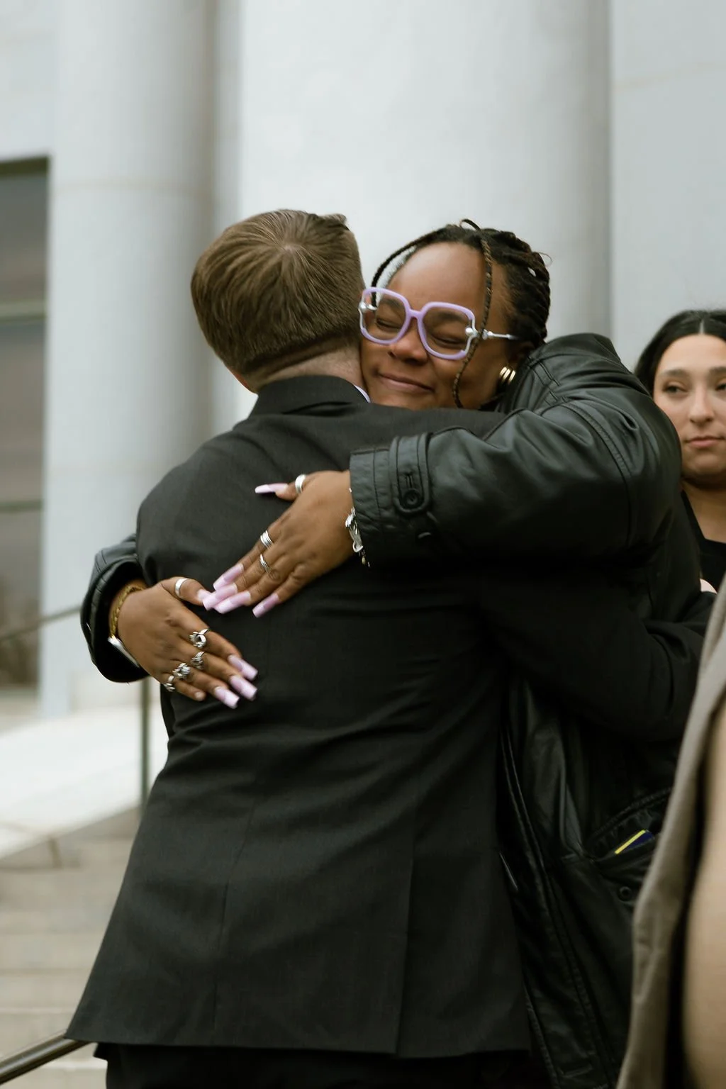 Candid Hug Between Groom and Guest at an Intimate Denver Courthouse Microwedding