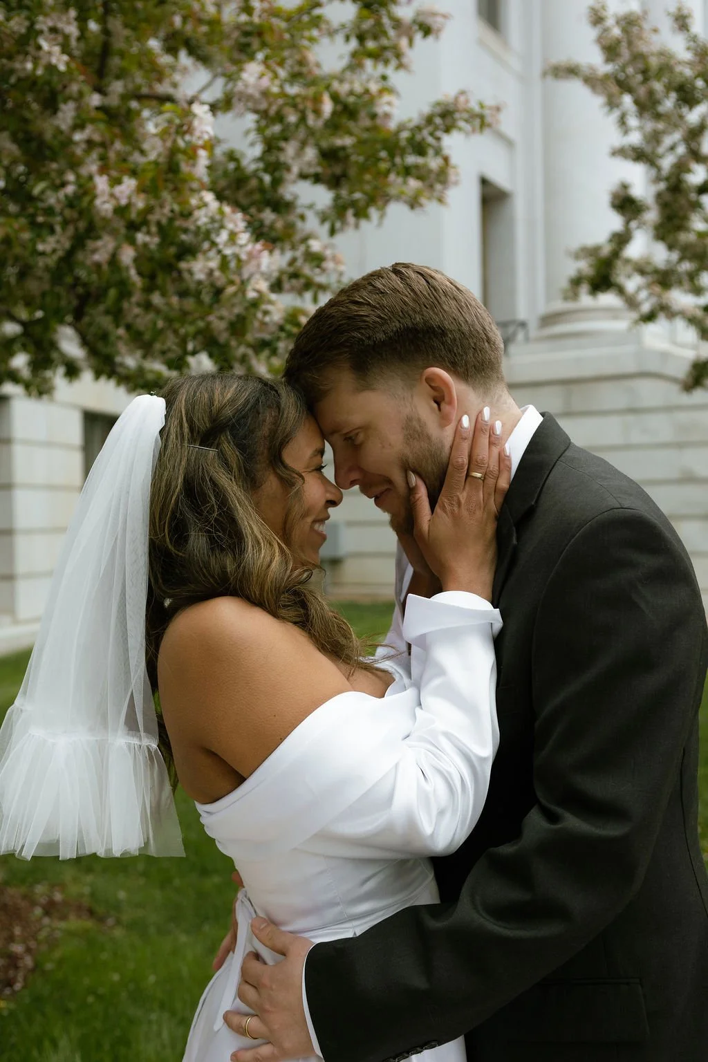 Intimate moment between bride and groom on their elopement day at the denver courthouse