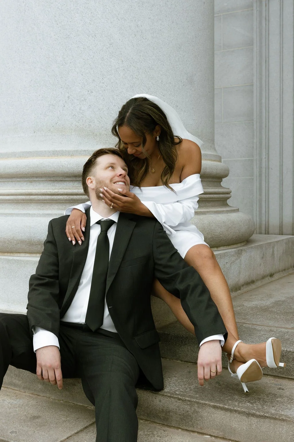 Playful and Romantic Moment between Bride and Groom on the Denver Courthouse Steps