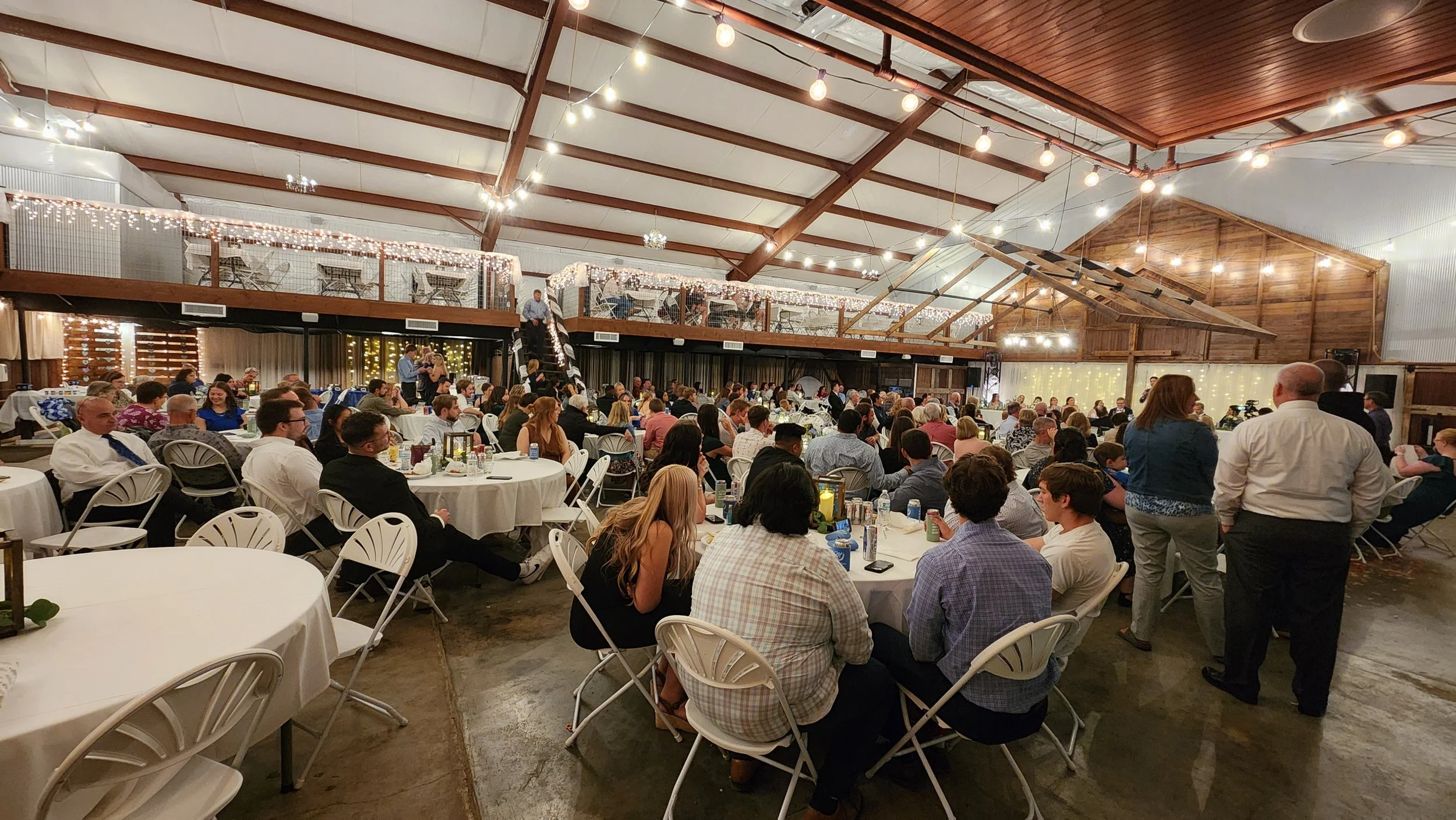 Set up of wedding reception inside at the Kansas Beach with people.