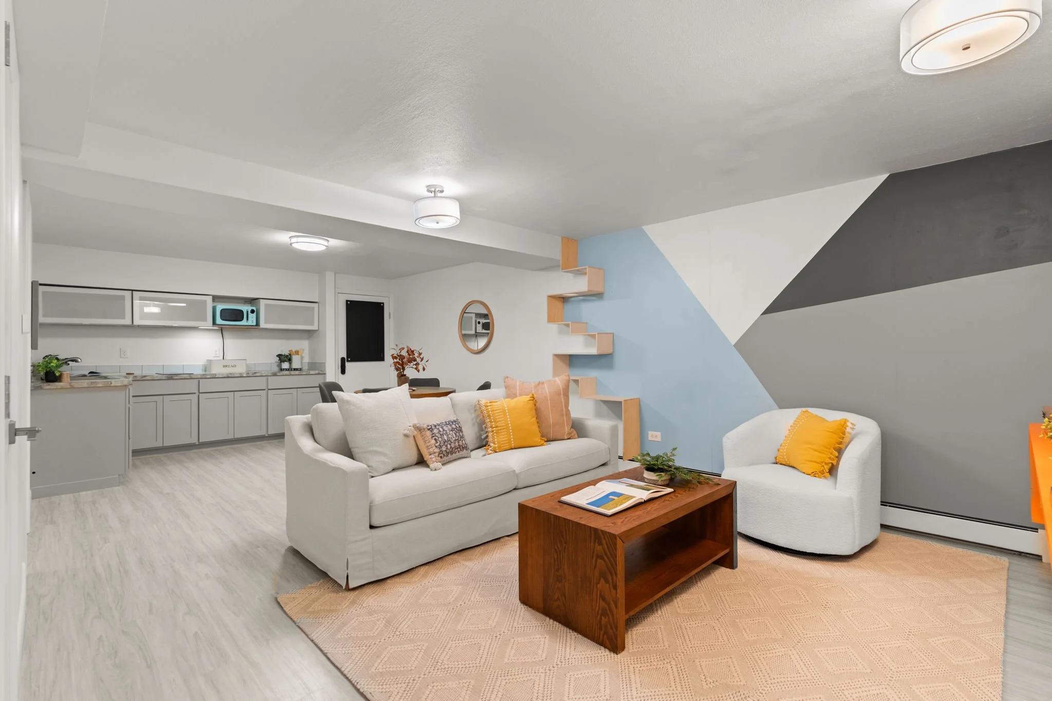 Mother-in-law suite in basement features a secondary living area, two bedrooms, kitchenette, bathroom, laundry, and abundant storage