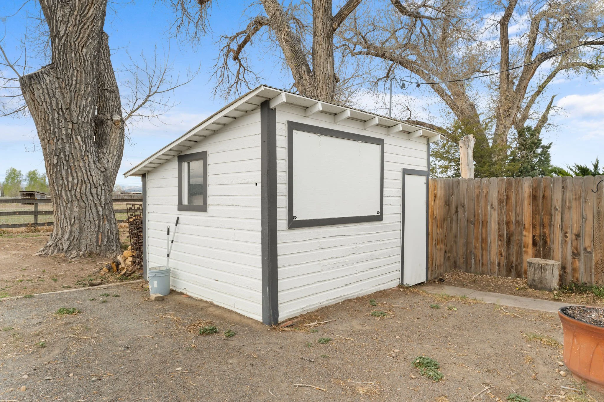 This shed features a TV behind the dropdown window for outdoor entertainment