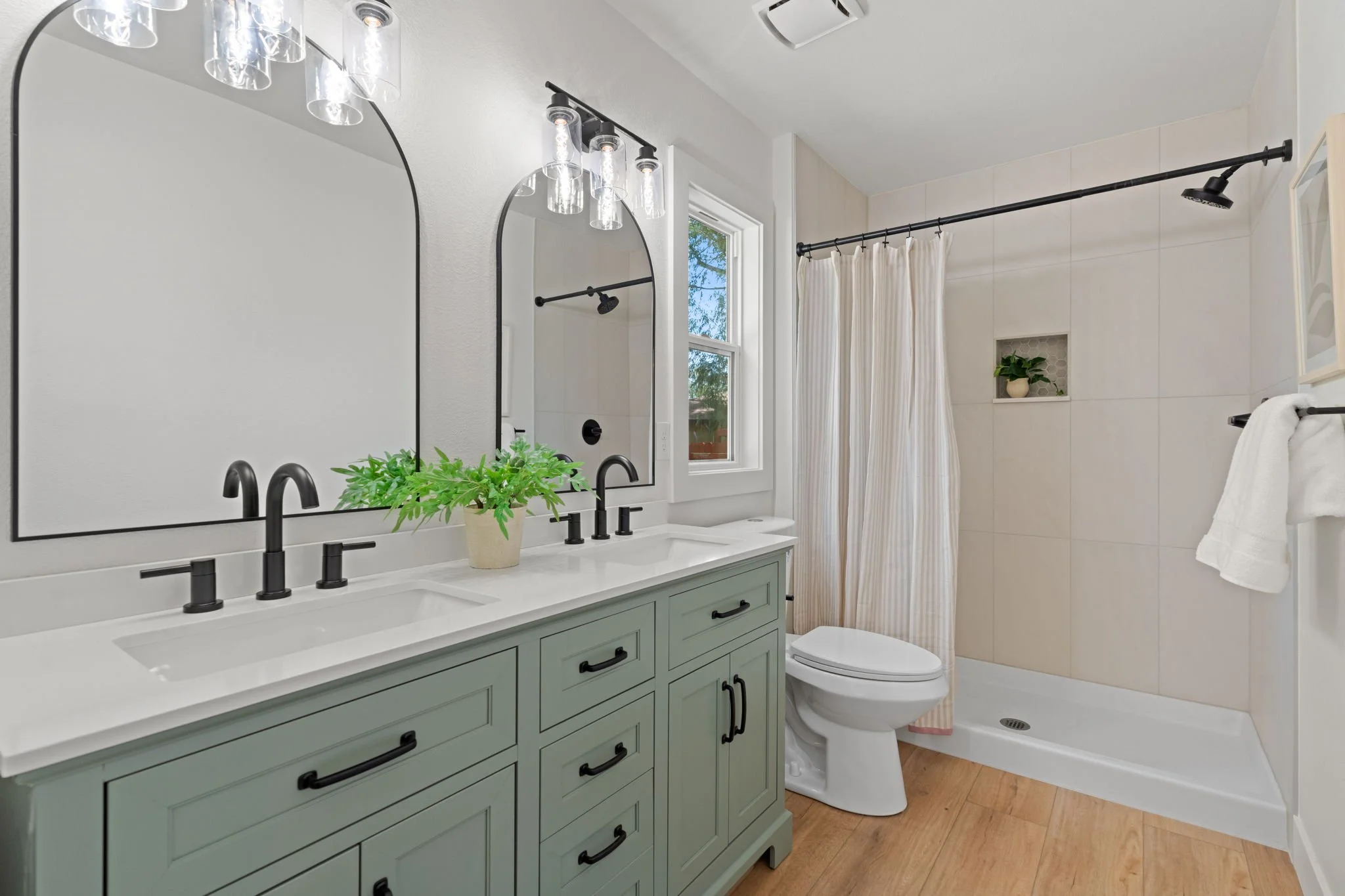 Beautifully remodeled primary bathroom featuring a custom tile shower surround