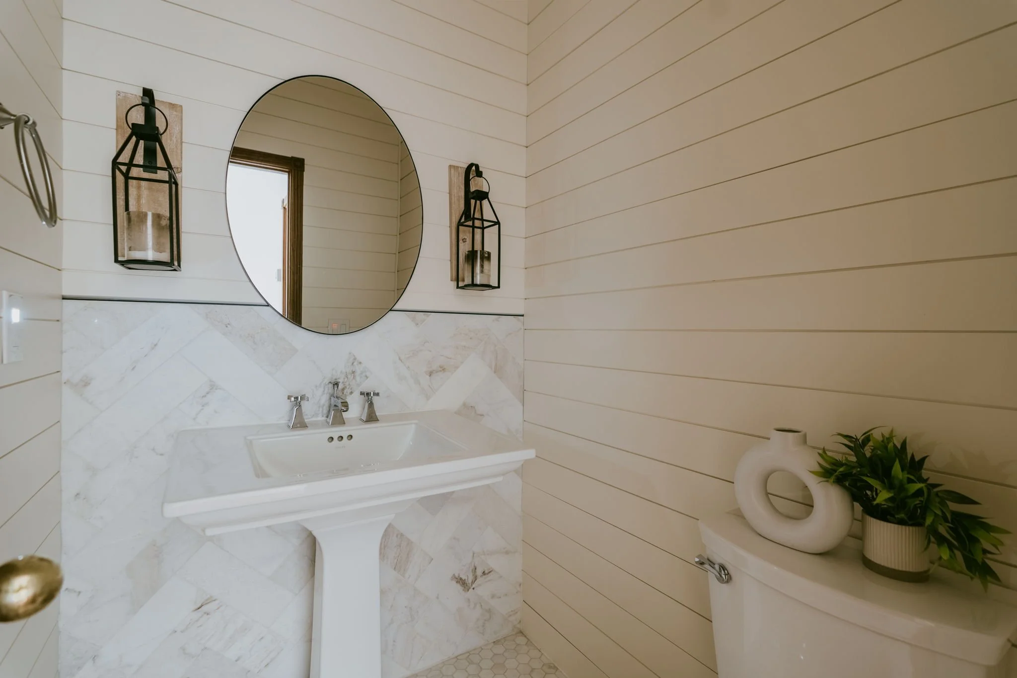 Main floor powder bath with marble tile