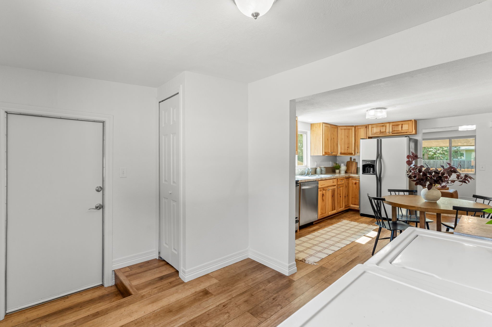 LVP flooring extends into the laundry room and bathroom