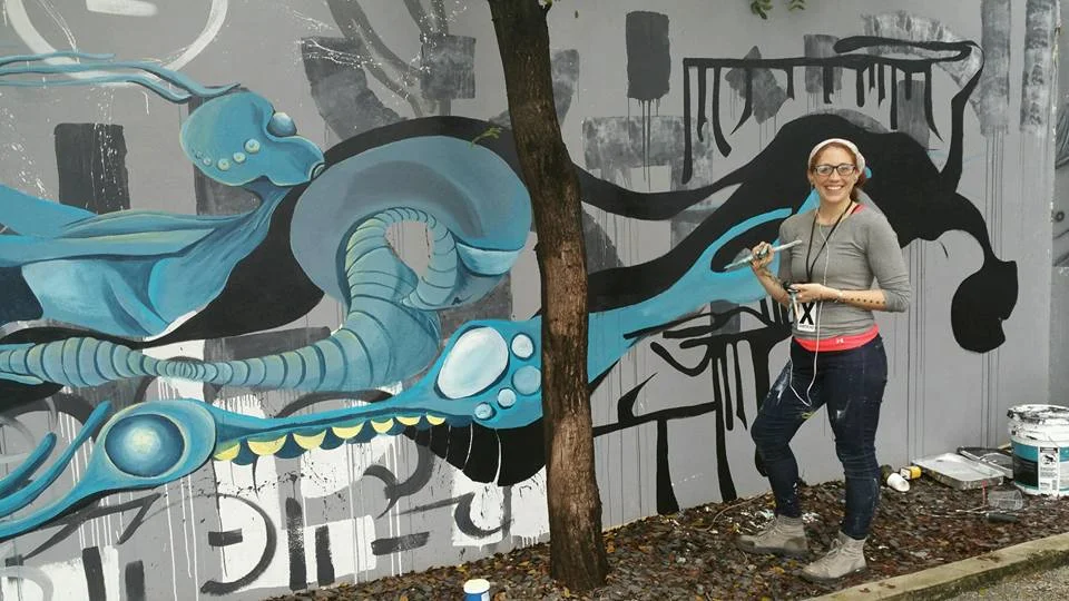Lana Price working on a mural in Miami Art Basel 