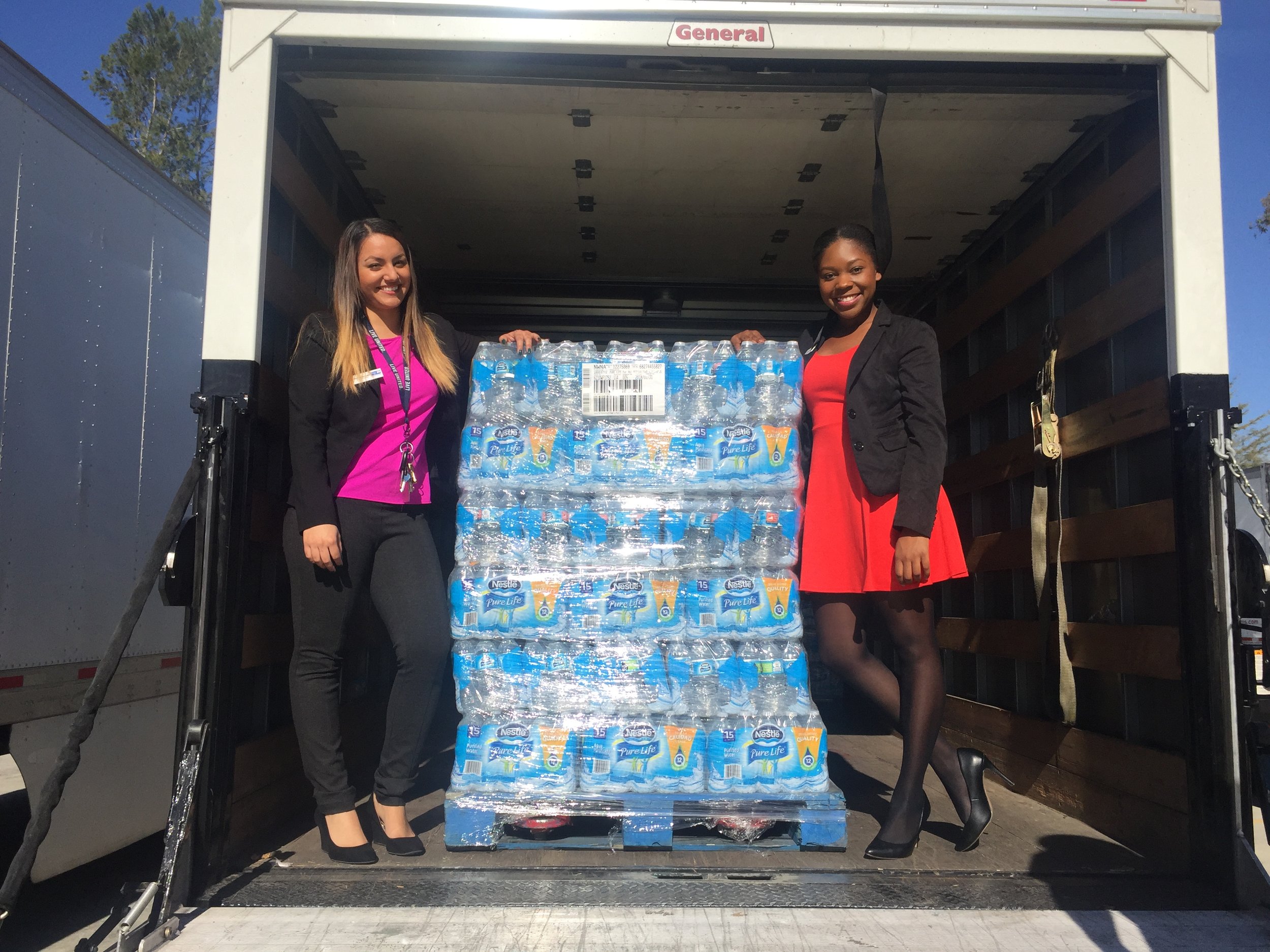 Jasmine and her coworker, Marie collect a Nestle Donation for the IEUW Kids Pack Program. 