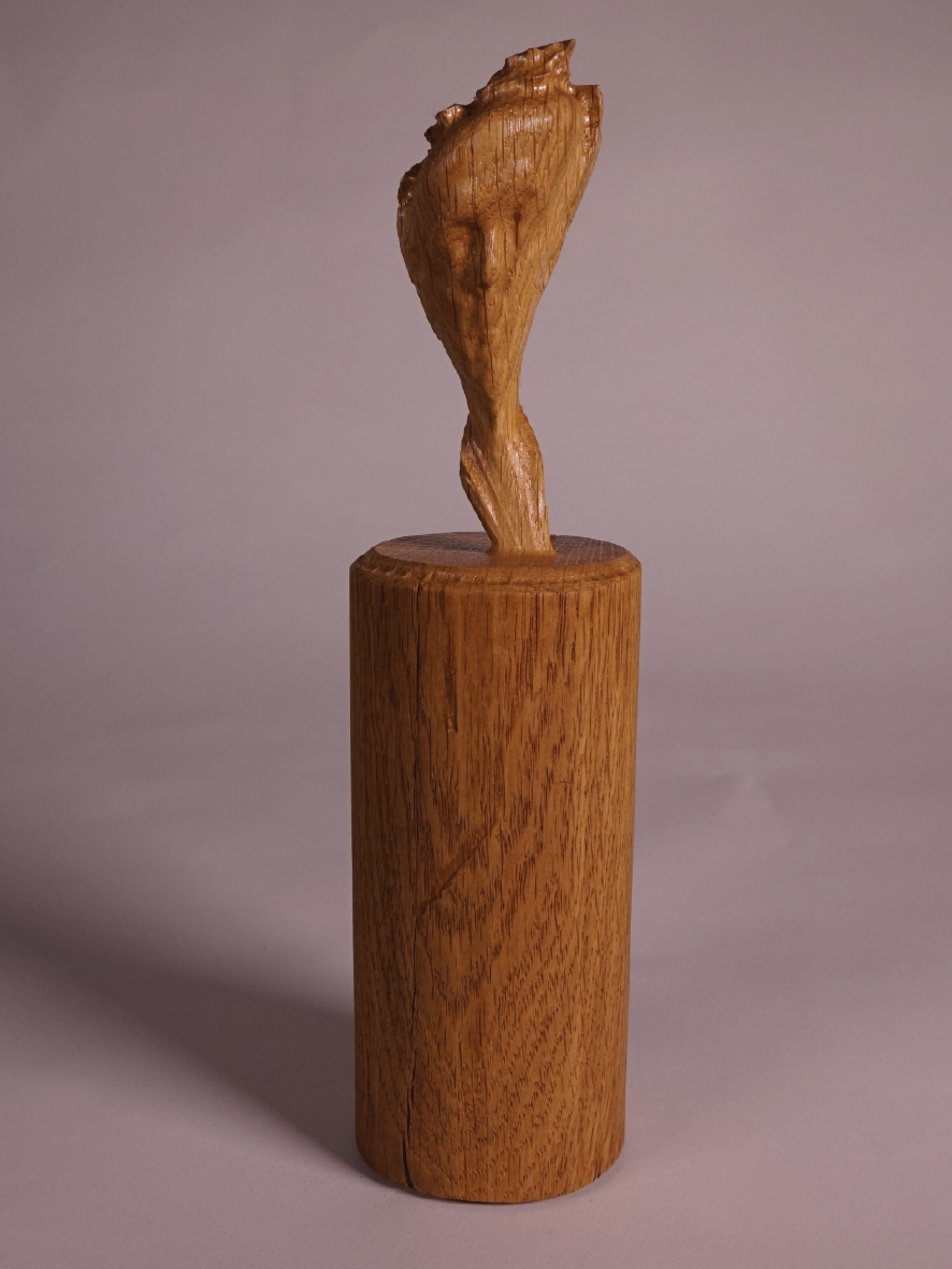 skewed wooden bust of self