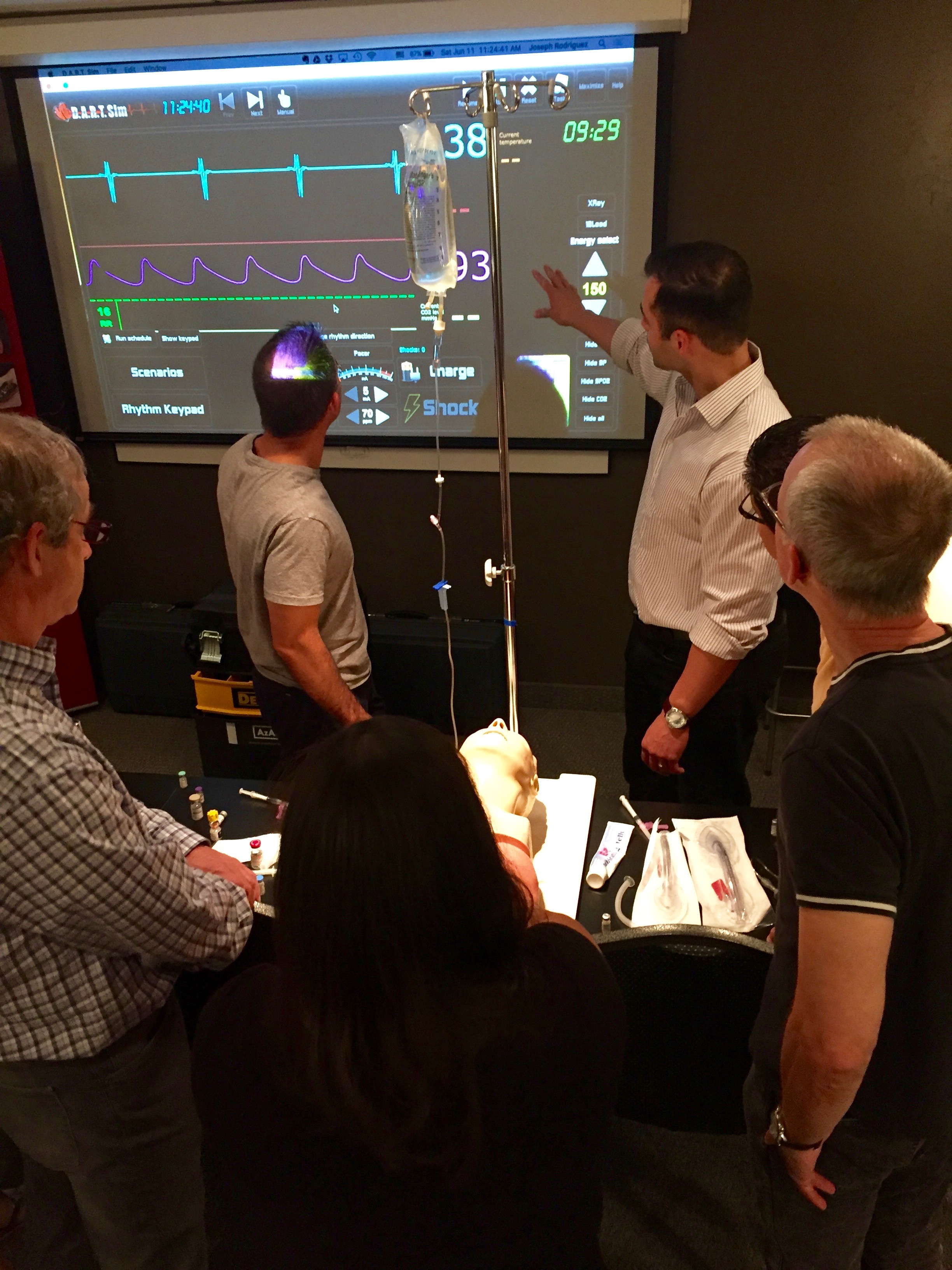  Joe Rodriguez, CRNA, reviews emergency heart rhythm management. &nbsp;Pictured here with Drs. Ken Kimble, DDS, Ralph Price DDS, and Alan Ferguson, DDS. &nbsp; 