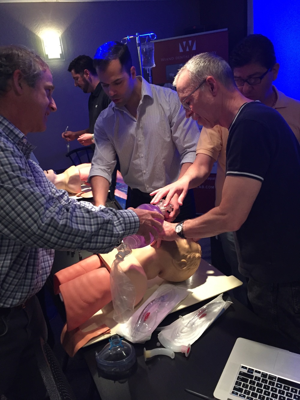  Joe Rodriguez, CRNA, offering hands-on airway instruction. &nbsp;Pictured here with Dr. Ralph Price and Dr. Alan Ferguson. &nbsp; 