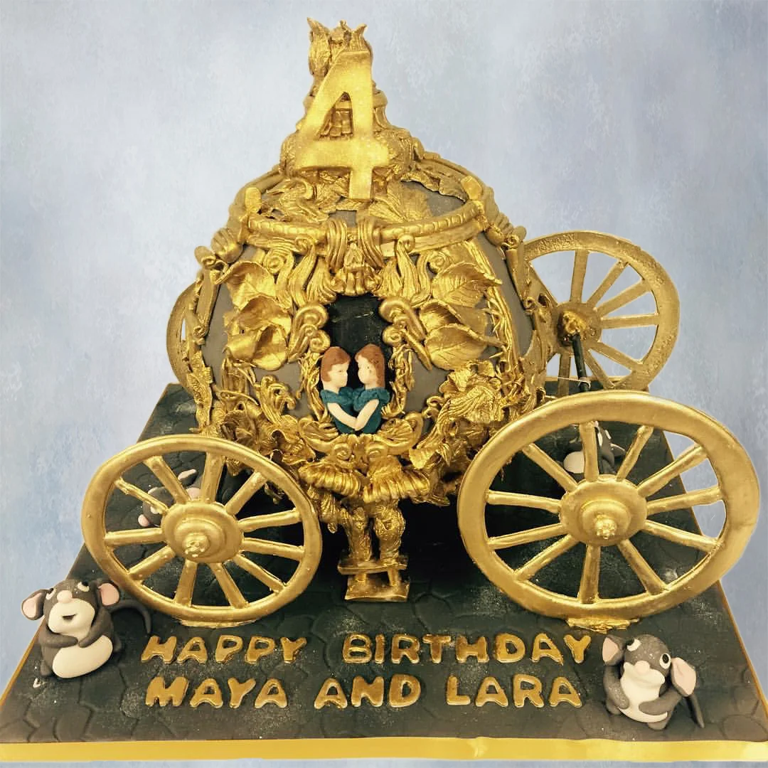 A 3D gold carriage cake for 4 year old twins