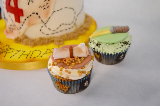 Pirate themed cupckes with sword and treasure map