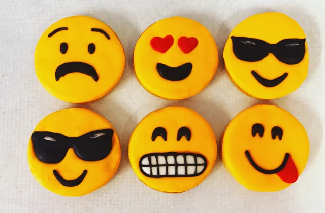 Hand piped Emoji biscuits