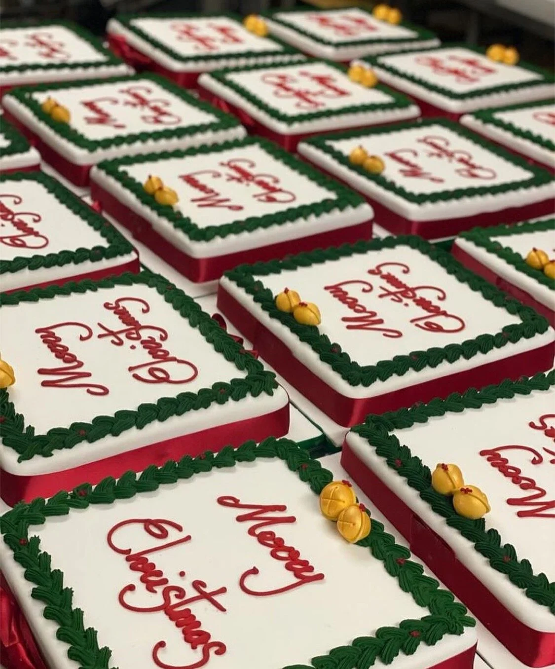 Hand piped Christmas cakes for NHS with gold chocolate bells at the top