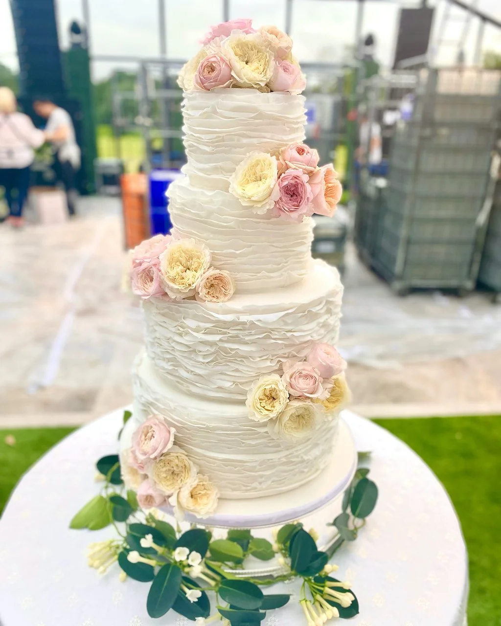 Luxury 4 tier wedding cake with sugarpaste ruffles and sugar flower roses
