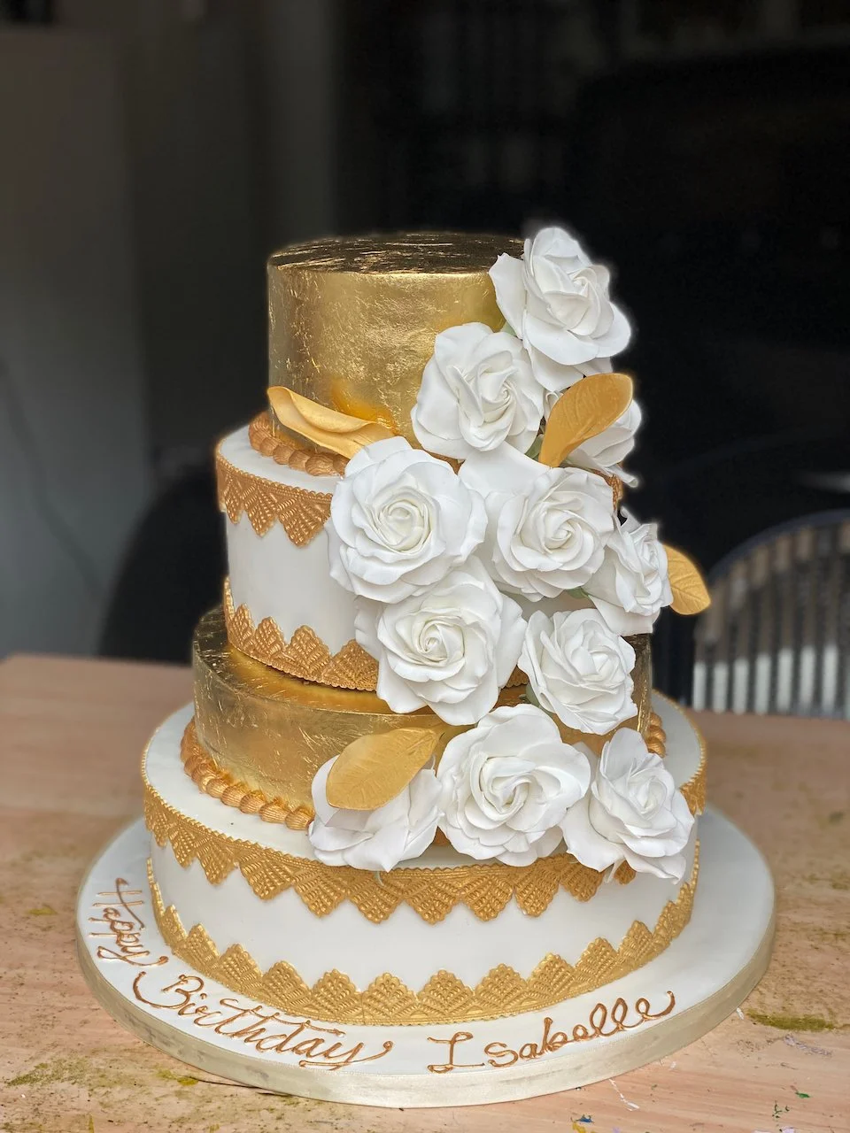 Gold and white 4 tier wedding cake with sugarflower roses