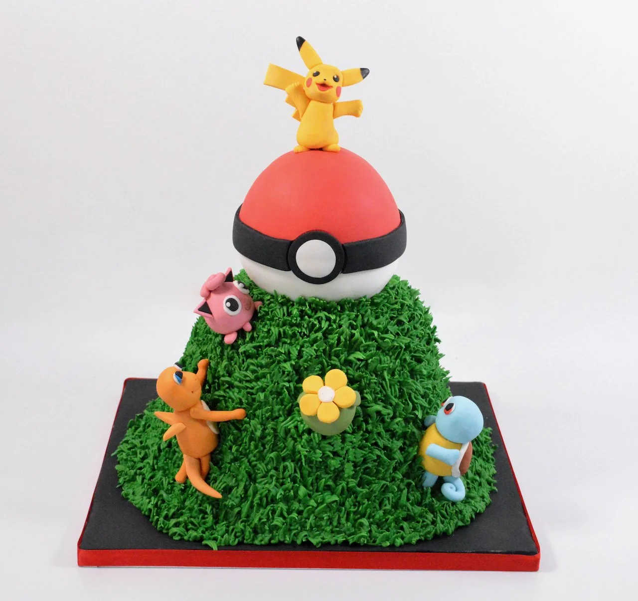 Pokemon ball sitting on a grass hill with other pokemon characters