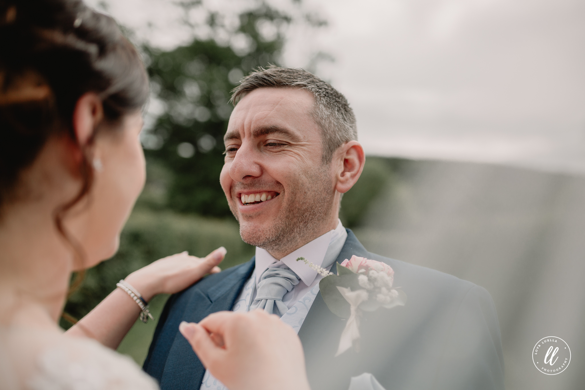 The groom looking at his wife with pride
