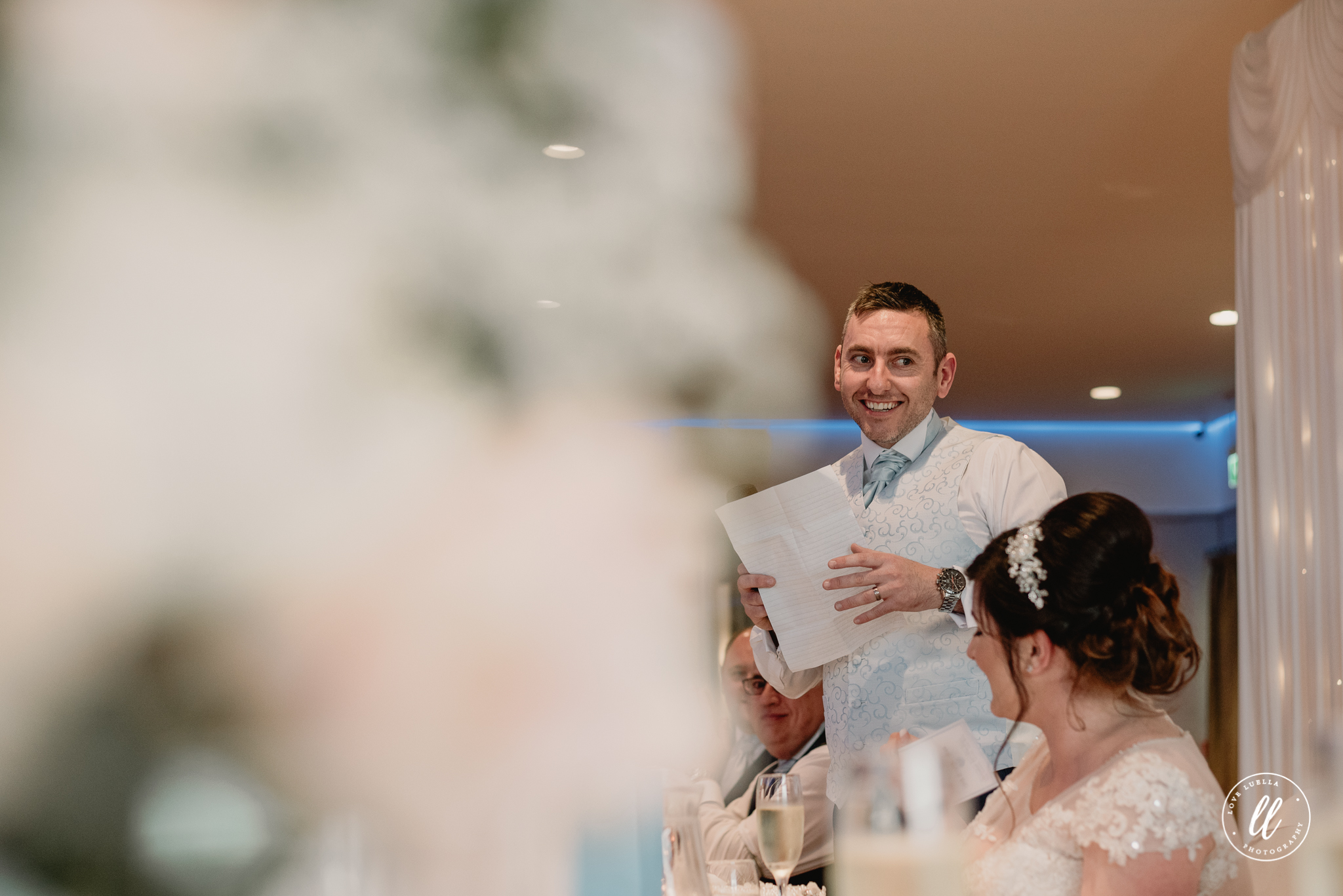 the groom starting his speech with a big grin