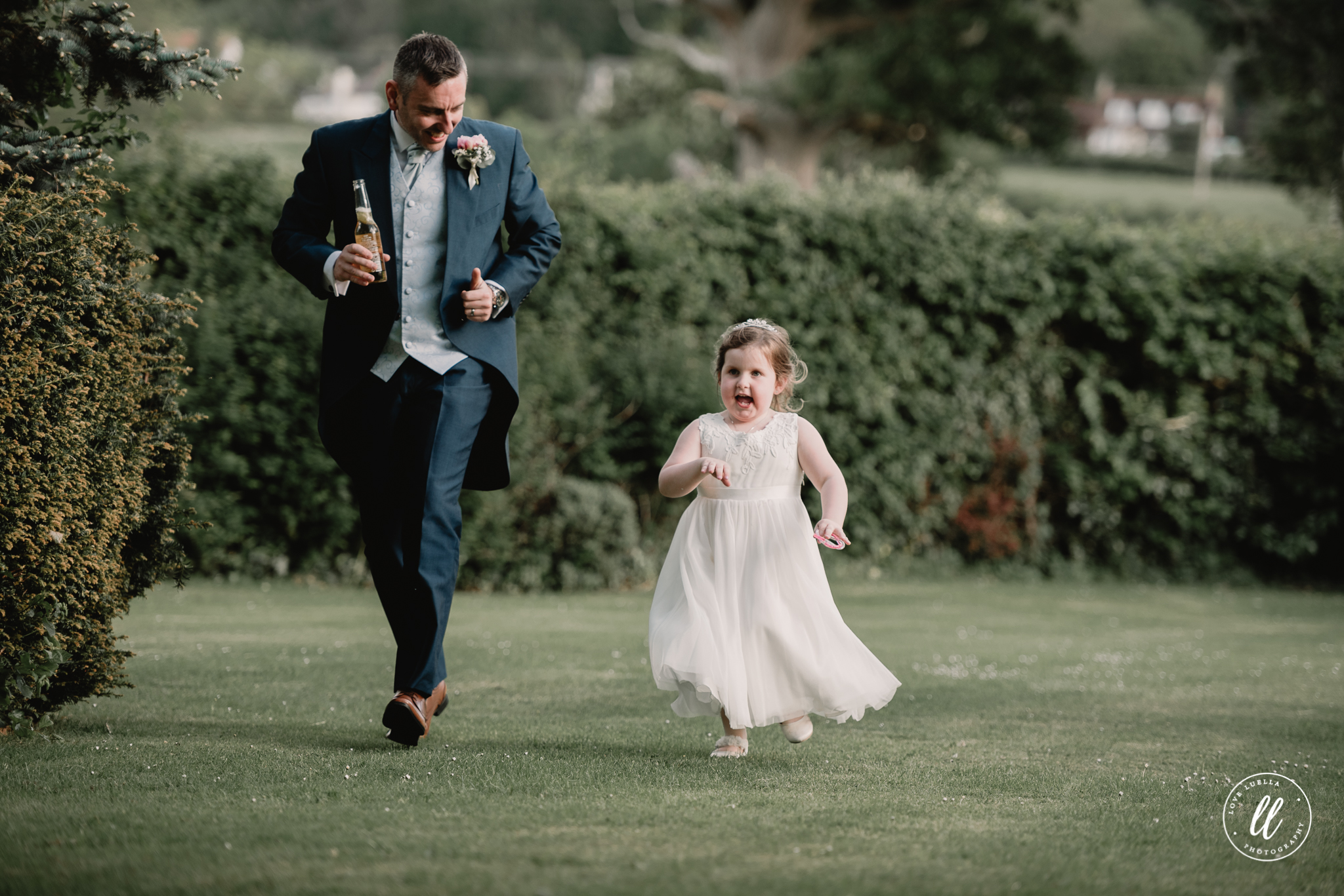 Father and daughter playfully running on the wedding day